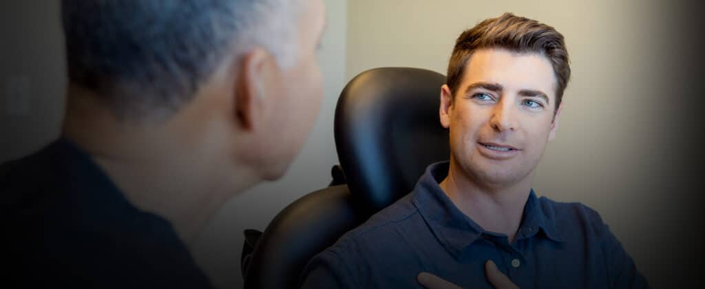 Dr. Delgado discussing gynecomastia with a patient.