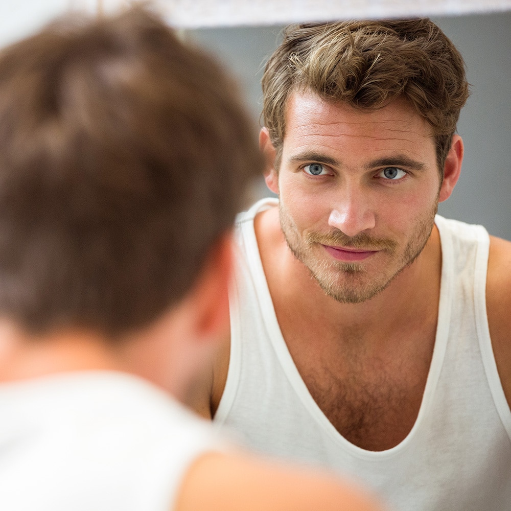 Man looking at himself in the mirror
