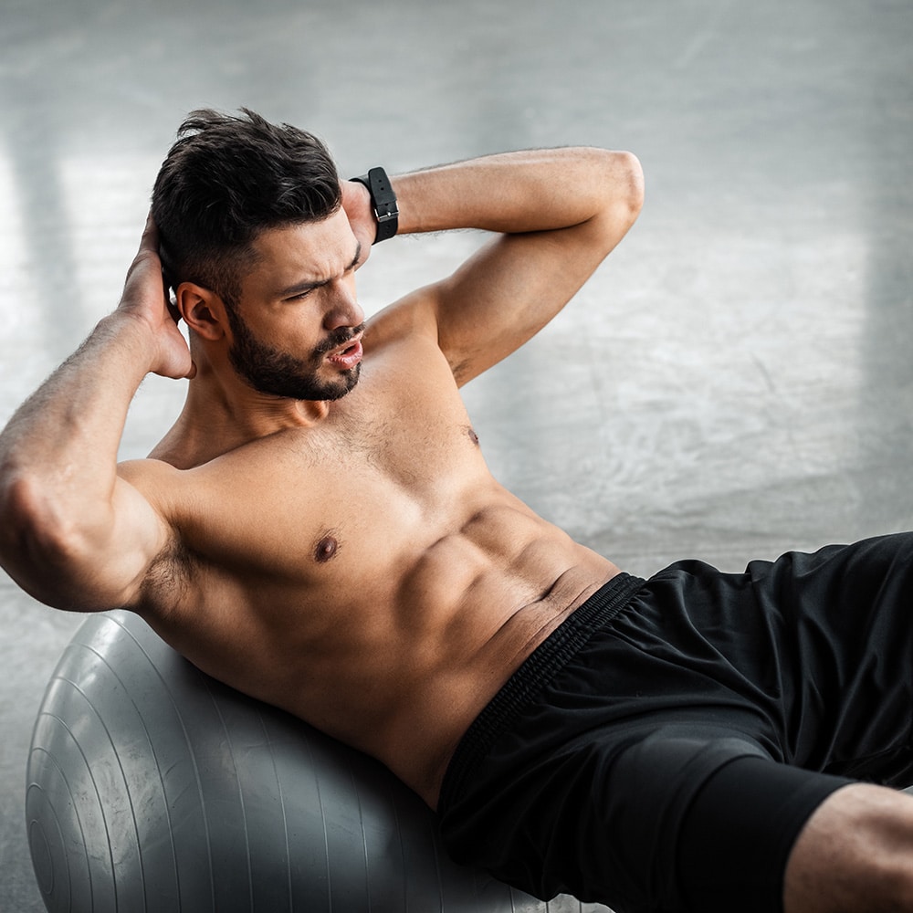 Man doing crunches on a medicine ball